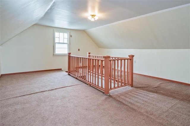 bonus room with baseboards, carpet flooring, and vaulted ceiling
