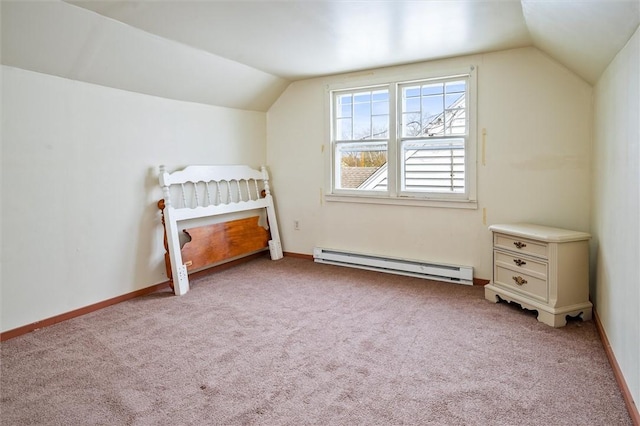 bedroom with baseboards, baseboard heating, vaulted ceiling, and light carpet