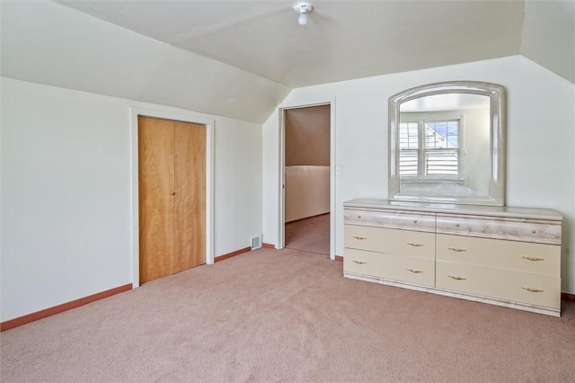 bonus room with baseboards, vaulted ceiling, light carpet, and visible vents