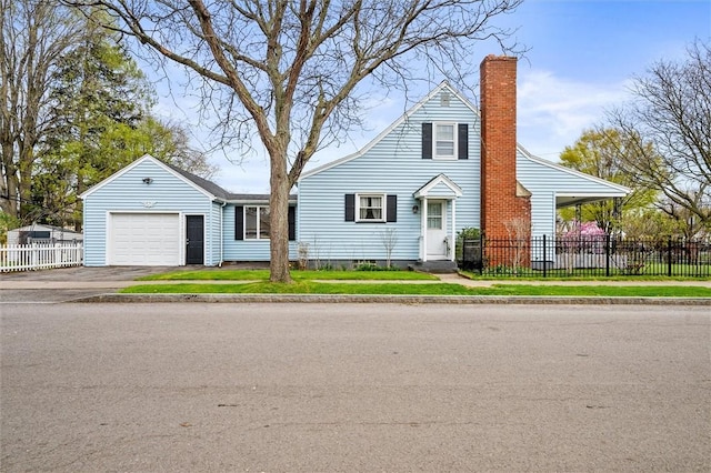 view of front facade with a garage, fence, a chimney, and aphalt driveway