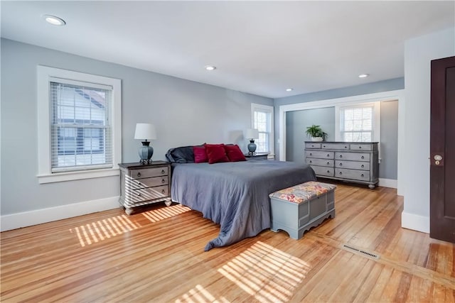 bedroom featuring baseboards, recessed lighting, light wood-style flooring, and visible vents