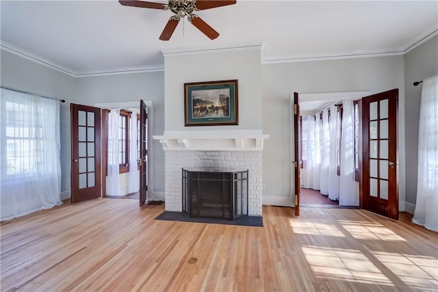 unfurnished living room featuring crown molding, plenty of natural light, and french doors