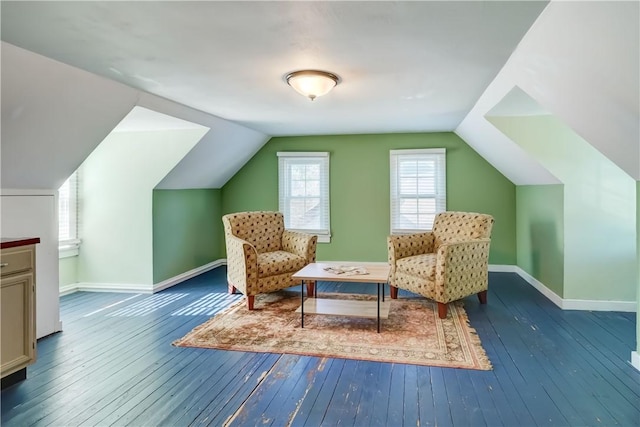 sitting room featuring baseboards, wood-type flooring, and vaulted ceiling