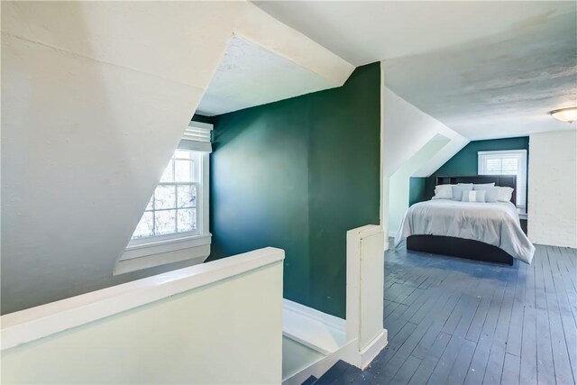 bedroom with lofted ceiling and hardwood / wood-style floors