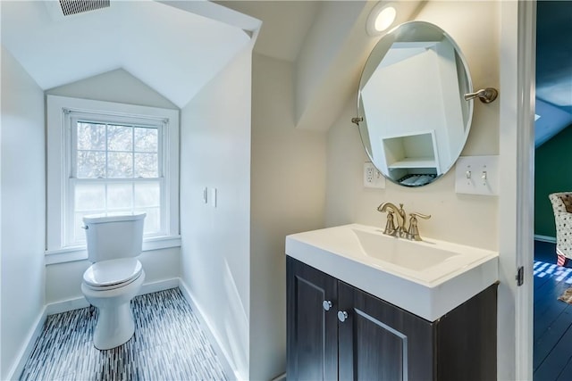 bathroom featuring baseboards, vaulted ceiling, toilet, and visible vents