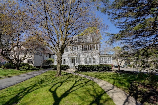 colonial-style house with a front yard