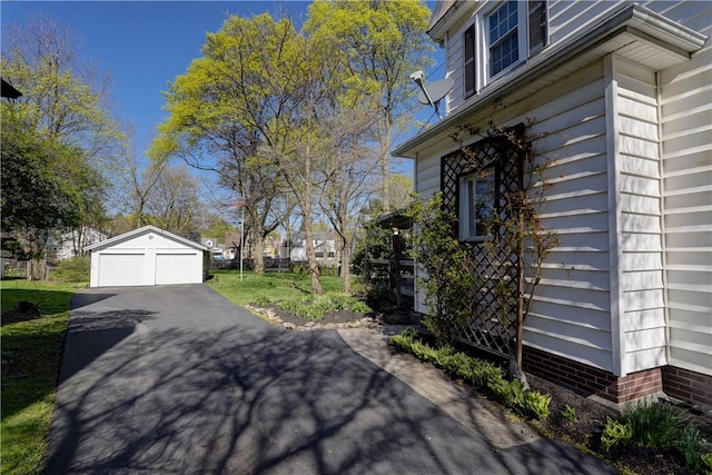 view of side of property with an outdoor structure and a garage