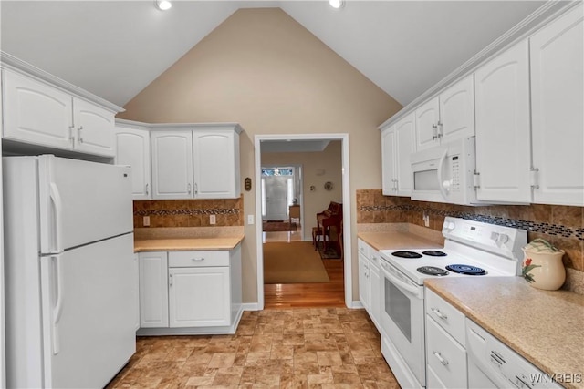 kitchen with decorative backsplash, white cabinetry, white appliances, and light countertops
