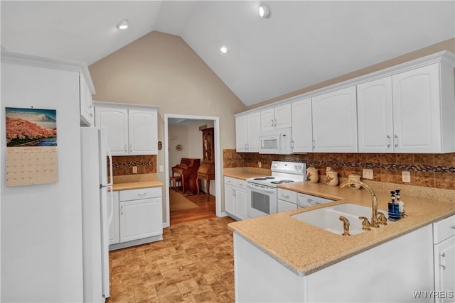 kitchen featuring white appliances, white cabinets, a sink, and light countertops