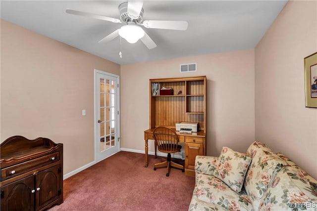 office space with baseboards, a ceiling fan, carpet floors, and visible vents
