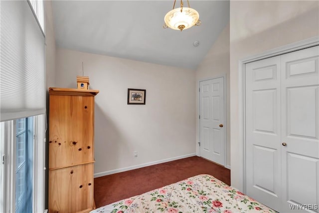 carpeted bedroom with baseboards, a closet, and lofted ceiling