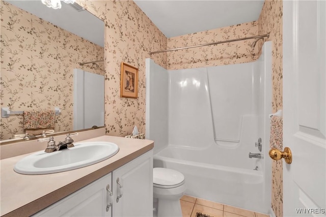 full bathroom featuring vanity, bathtub / shower combination, toilet, tile patterned floors, and wallpapered walls