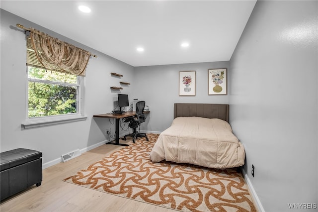 bedroom with visible vents, recessed lighting, baseboards, and wood finished floors