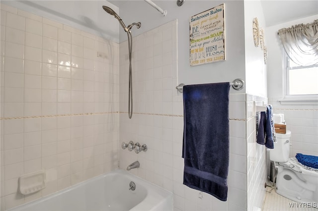 bathroom with shower / bath combination, tile walls, tile patterned flooring, and toilet