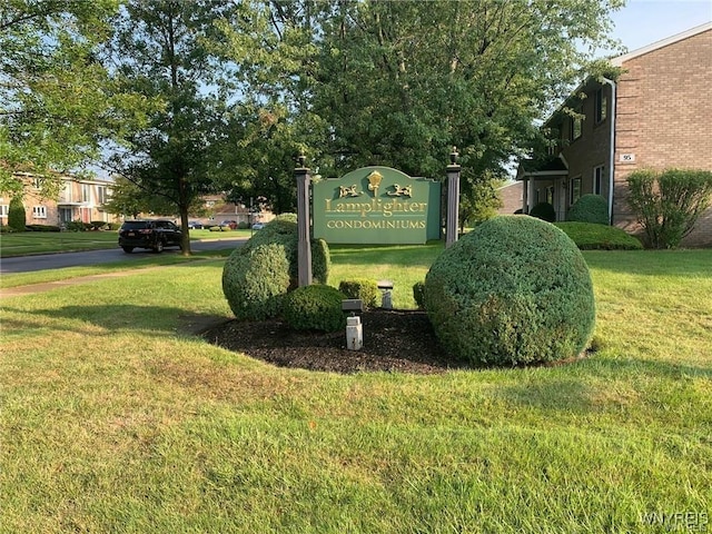 community / neighborhood sign with a lawn