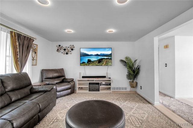 living room with recessed lighting, baseboards, visible vents, and wood finished floors