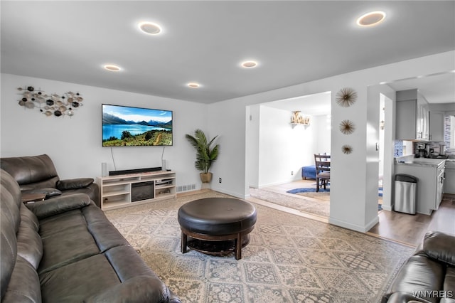 living room with baseboards, recessed lighting, and visible vents