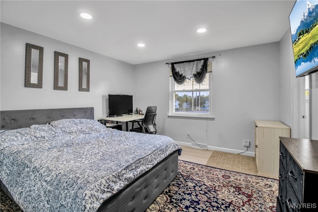 bedroom featuring baseboards, recessed lighting, wood finished floors, and visible vents