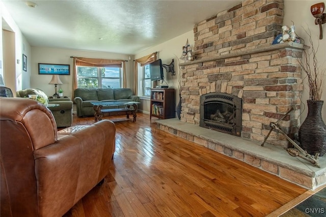 21959 County Route 59, Brownville, NY 13634 - living area with hardwood / wood-style flooring and a fireplace
