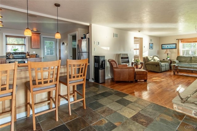 21959 County Route 59, Brownville, NY 13634 - dining room featuring stone tile flooring and visible vents