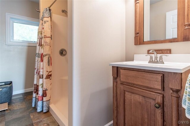 21959 County Route 59, Brownville, NY 13634 - full bathroom featuring vanity, baseboards, stone finish flooring, and a shower with shower curtain
