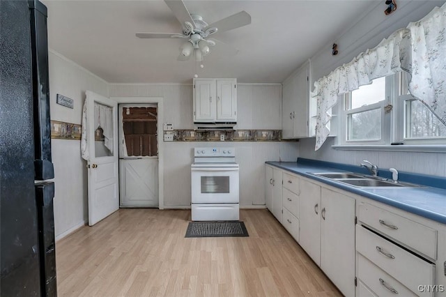 kitchen with white range with electric cooktop, ceiling fan, light wood-type flooring, white cabinetry, and a sink