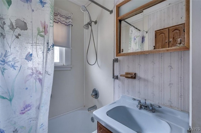 bathroom featuring a sink and shower / bath combination with curtain