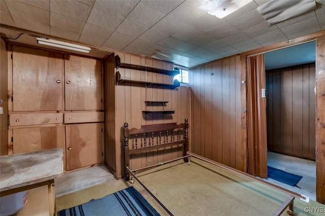 unfurnished bedroom featuring wood walls