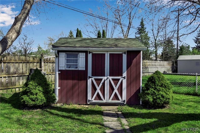 view of shed with a fenced backyard