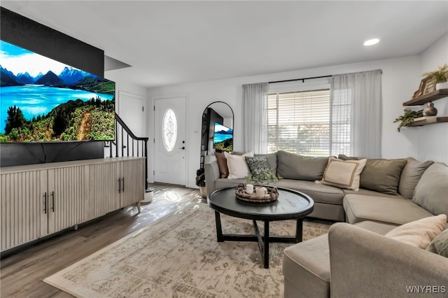 living room with light wood-style flooring and stairway