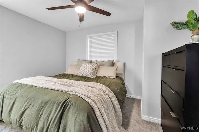 bedroom featuring baseboards, carpet flooring, and a ceiling fan