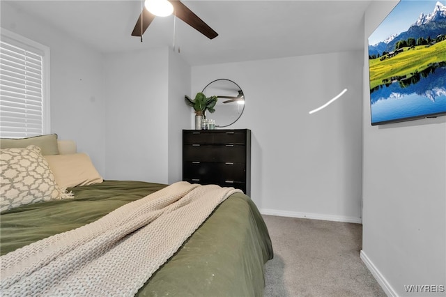 carpeted bedroom with a ceiling fan and baseboards