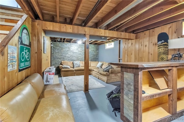interior space with concrete flooring and wood walls