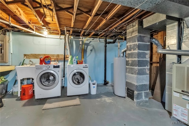 unfinished below grade area featuring water heater and separate washer and dryer