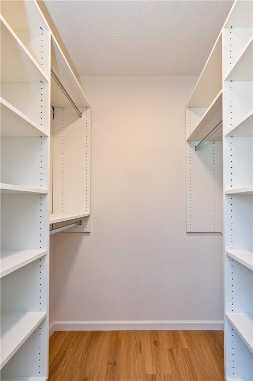 walk in closet featuring light wood-style flooring