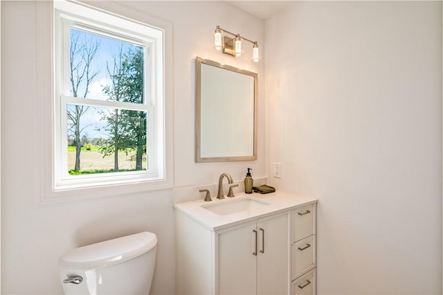half bathroom with toilet and vanity