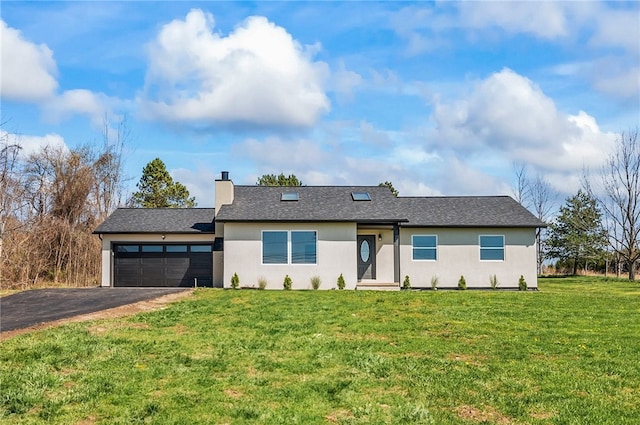 view of front of home featuring driveway, a chimney, a front yard, an attached garage, and stucco siding