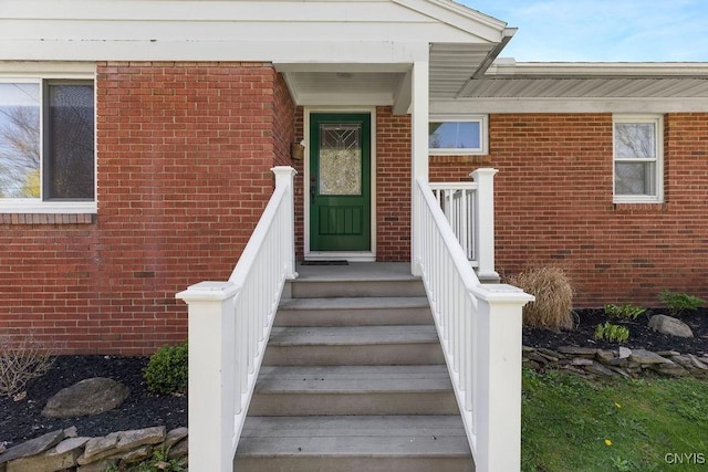 property entrance featuring brick siding