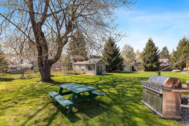 view of yard featuring fence and an outdoor structure