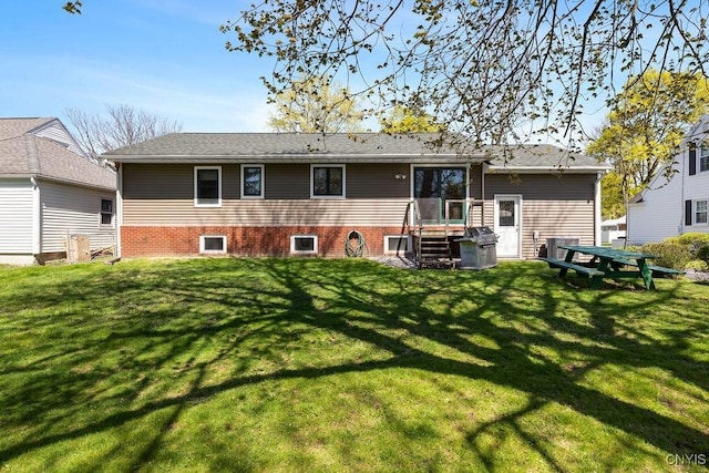 rear view of property featuring a yard