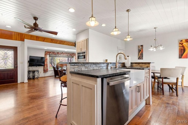 kitchen featuring stainless steel appliances, decorative light fixtures, wooden ceiling, wood finished floors, and a center island with sink