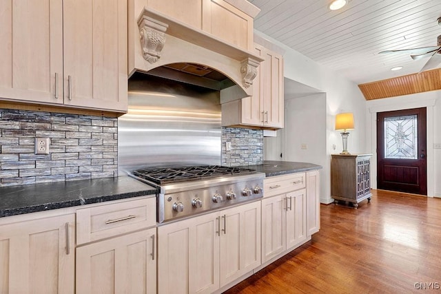 kitchen featuring wood ceiling, backsplash, stainless steel gas cooktop, custom range hood, and light wood-style flooring