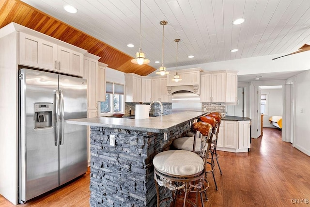 kitchen with recessed lighting, dark countertops, wood ceiling, and stainless steel fridge with ice dispenser