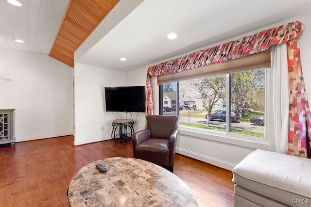 living area with baseboards, recessed lighting, and lofted ceiling
