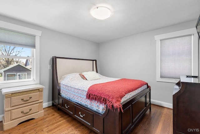 bedroom with baseboards and light wood finished floors
