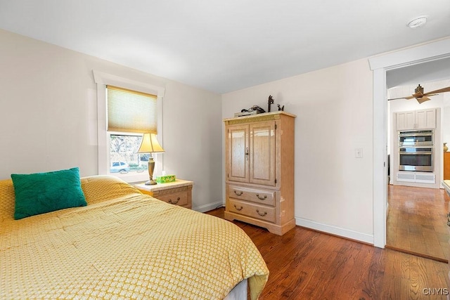 bedroom with baseboards and wood finished floors