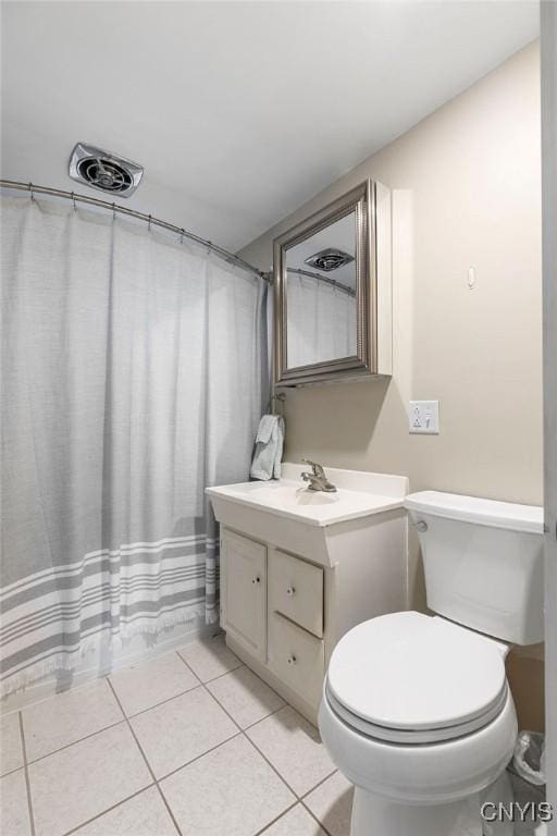 bathroom featuring toilet, tile patterned floors, visible vents, and vanity