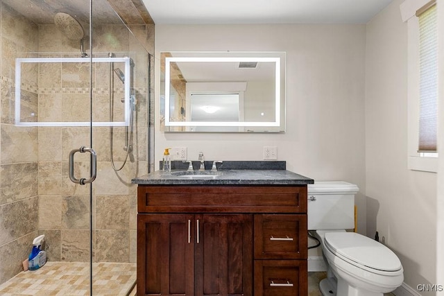 full bath with vanity, a shower stall, toilet, and visible vents