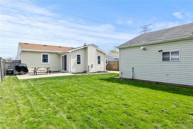 back of house featuring a lawn, a patio, cooling unit, and a fenced backyard