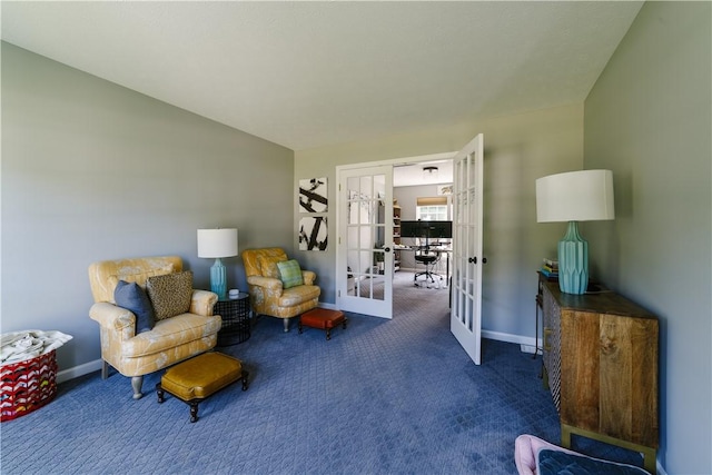 living area with carpet flooring, baseboards, and french doors